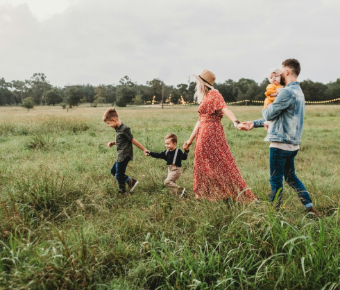 Famille marchant dans un champ et profitant d’une journée en plein air.